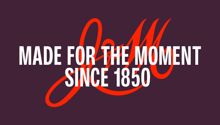 Johnston & Murphy purple banner that reads "Made For The Moment Since 1850" with red J&M Logo in the background.